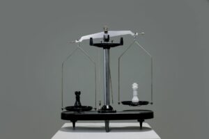a scale with black and white chess piece on each side